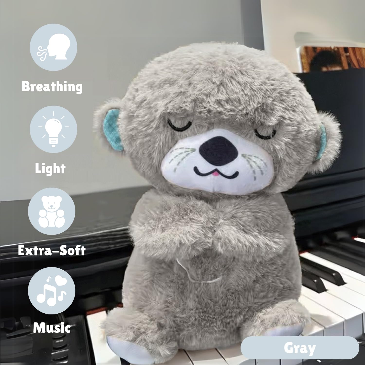 Gray teddy bear plush toy with features listed on a piano