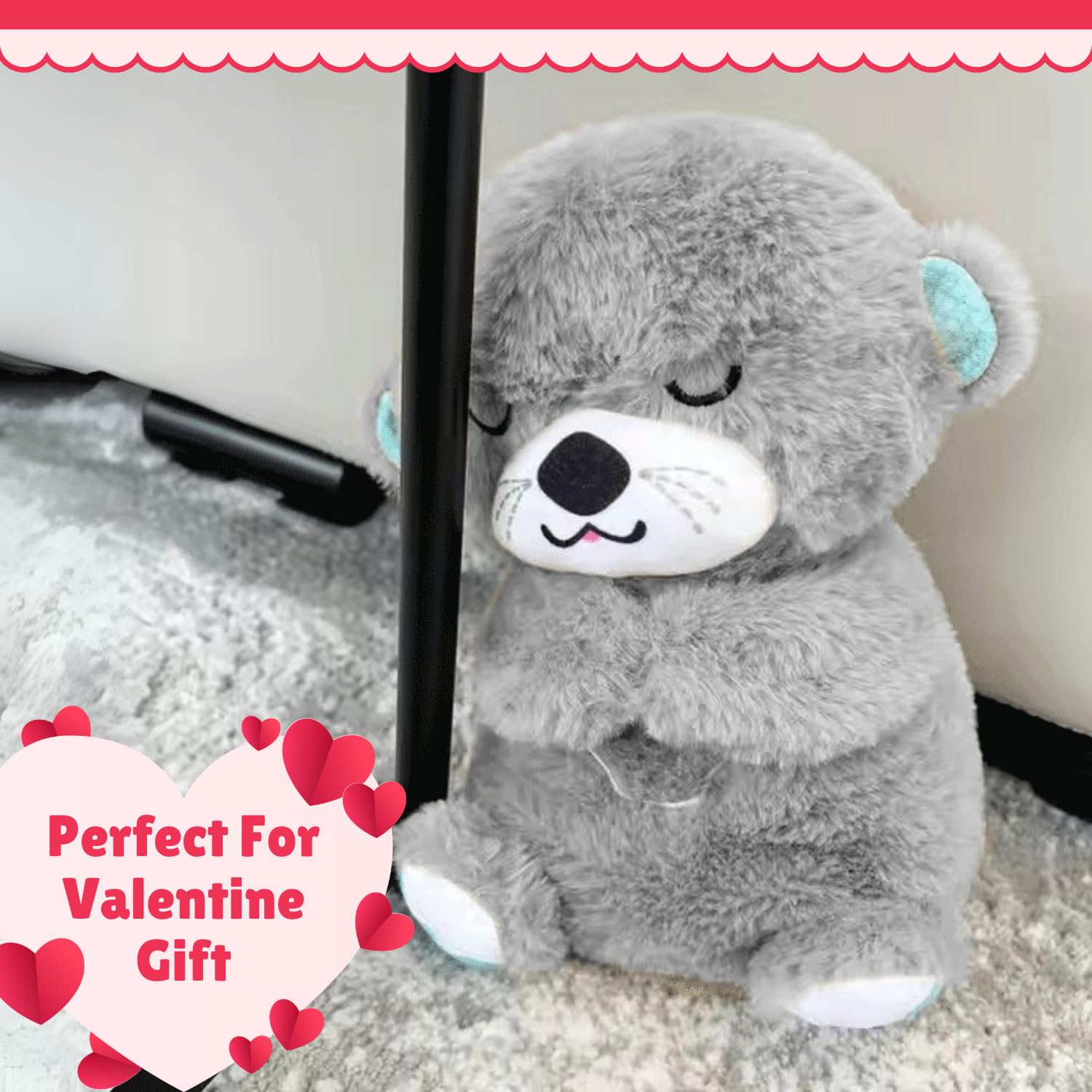 Gray teddy bear with closed eyes on a carpeted floor, labeled as a Valentine's Day gift.