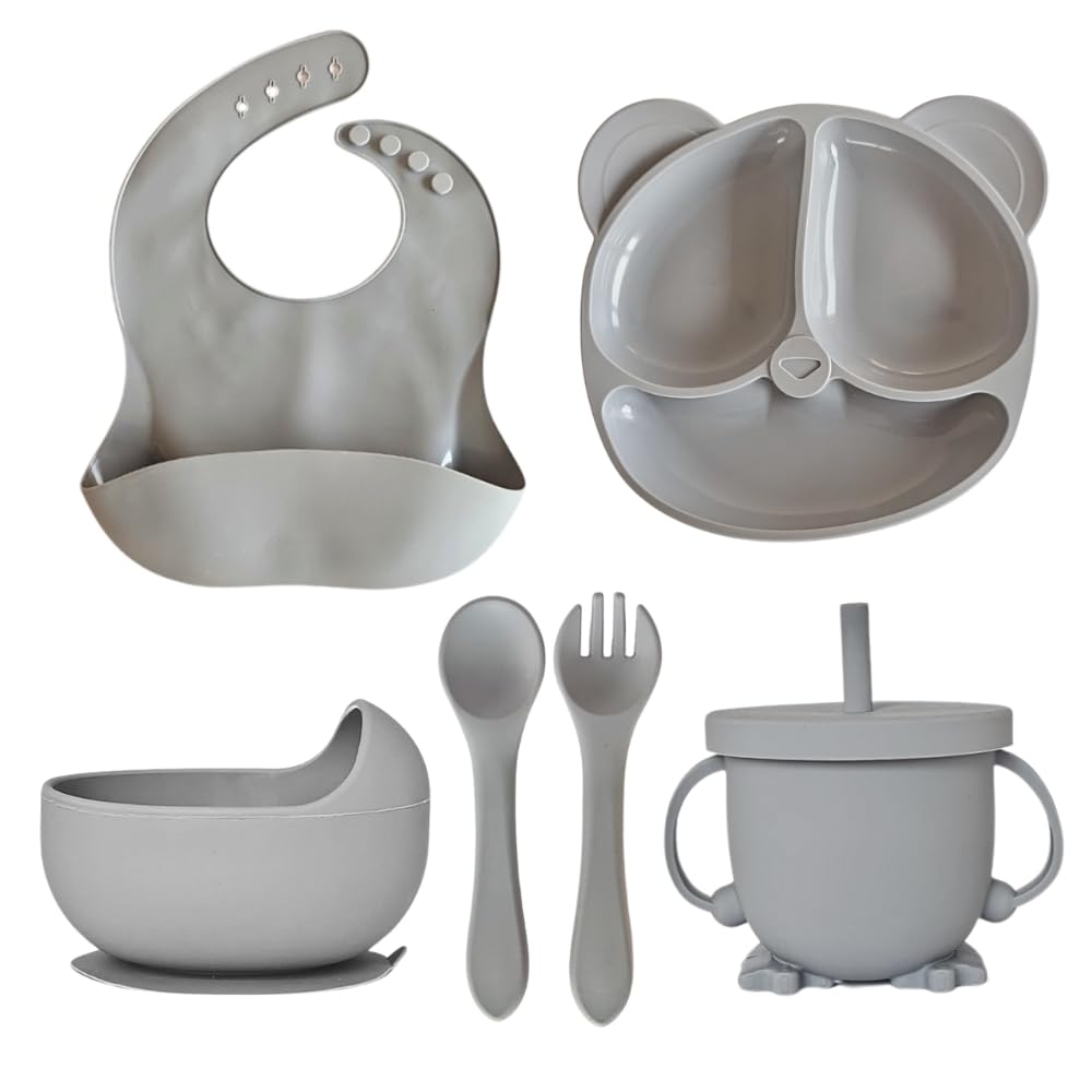 Soft blue 6-piece baby feeding set including bib, bowl, divided plate, spoon, fork, and sippy cup arranged neatly.