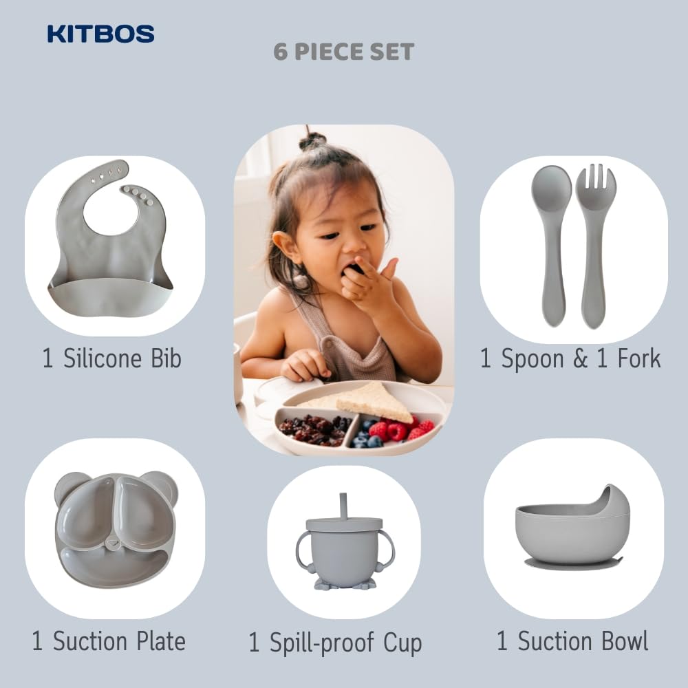 Smiling baby using soft blue feeding set at mealtime, holding spoon and drinking from sippy cup